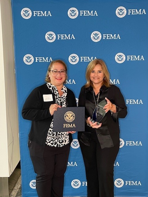 Two FEMA employees receive an award.
