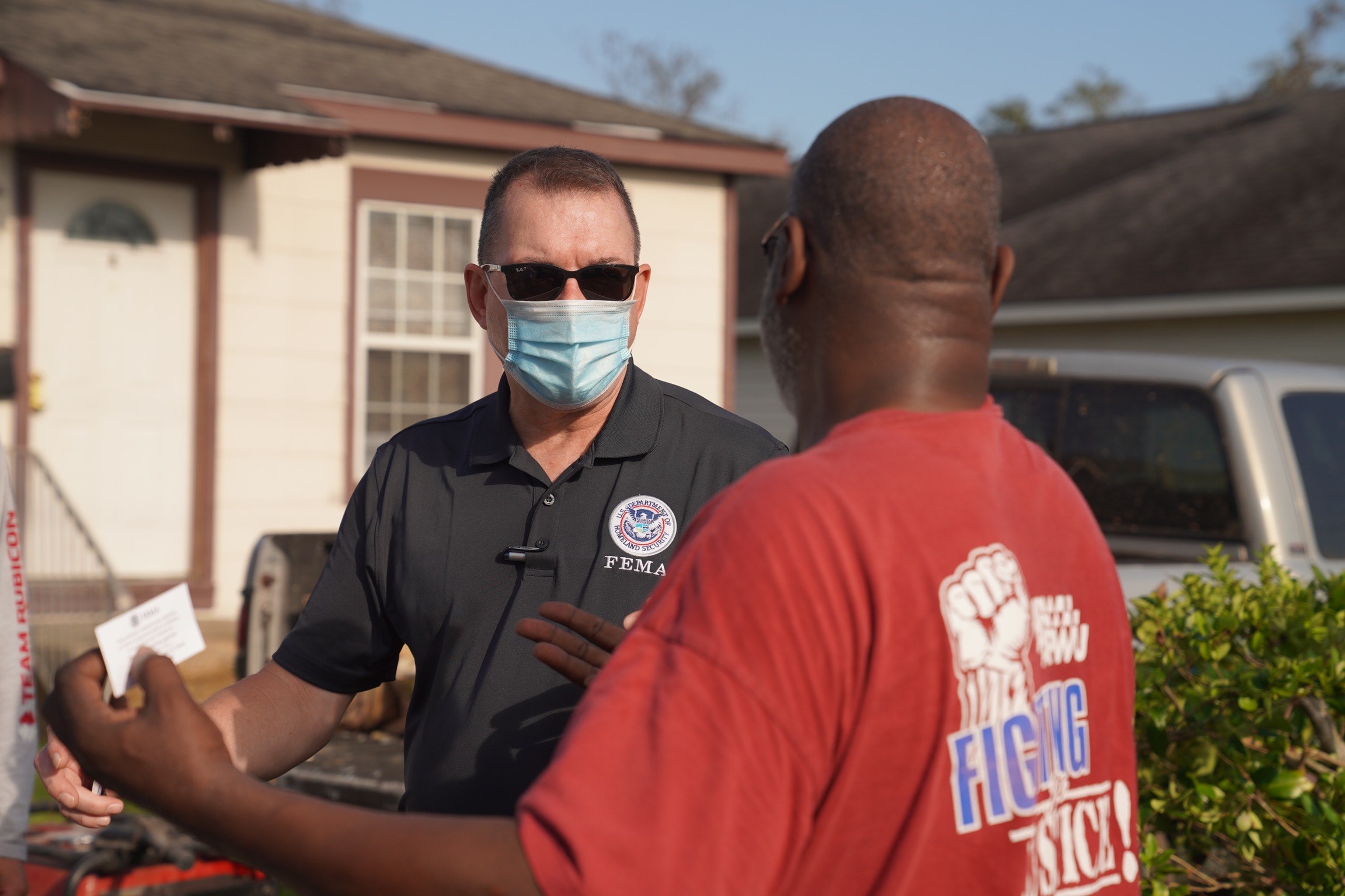 FEMA Administrator Pete Gaynor talks to a survivor outside of a home
