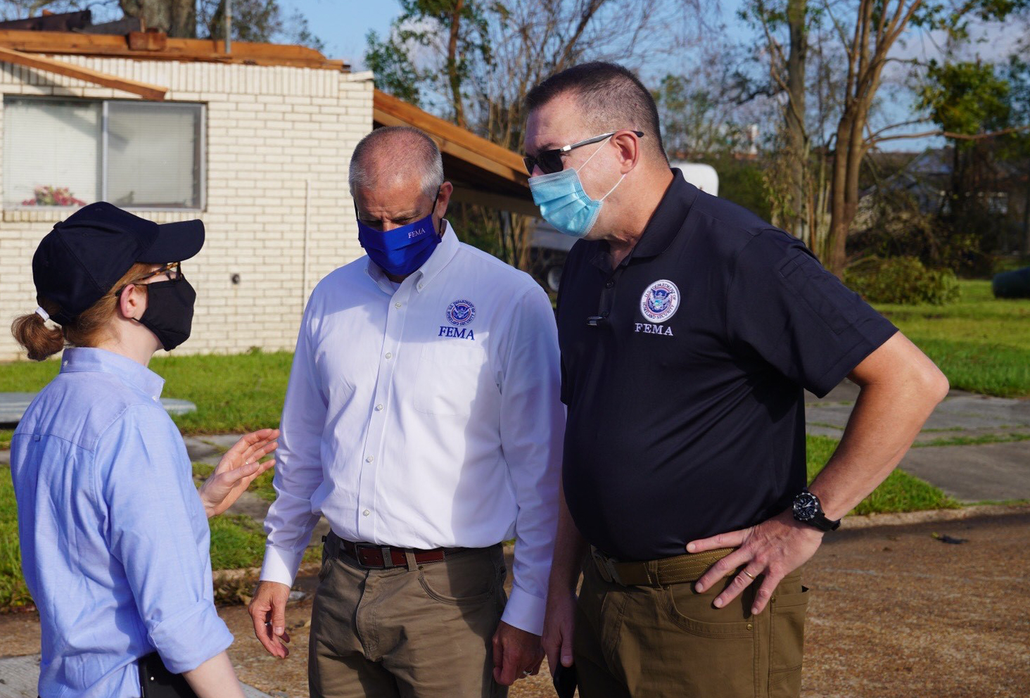 FEMA Administrator Gaynor speaks with staff while standing outside in Louisiana