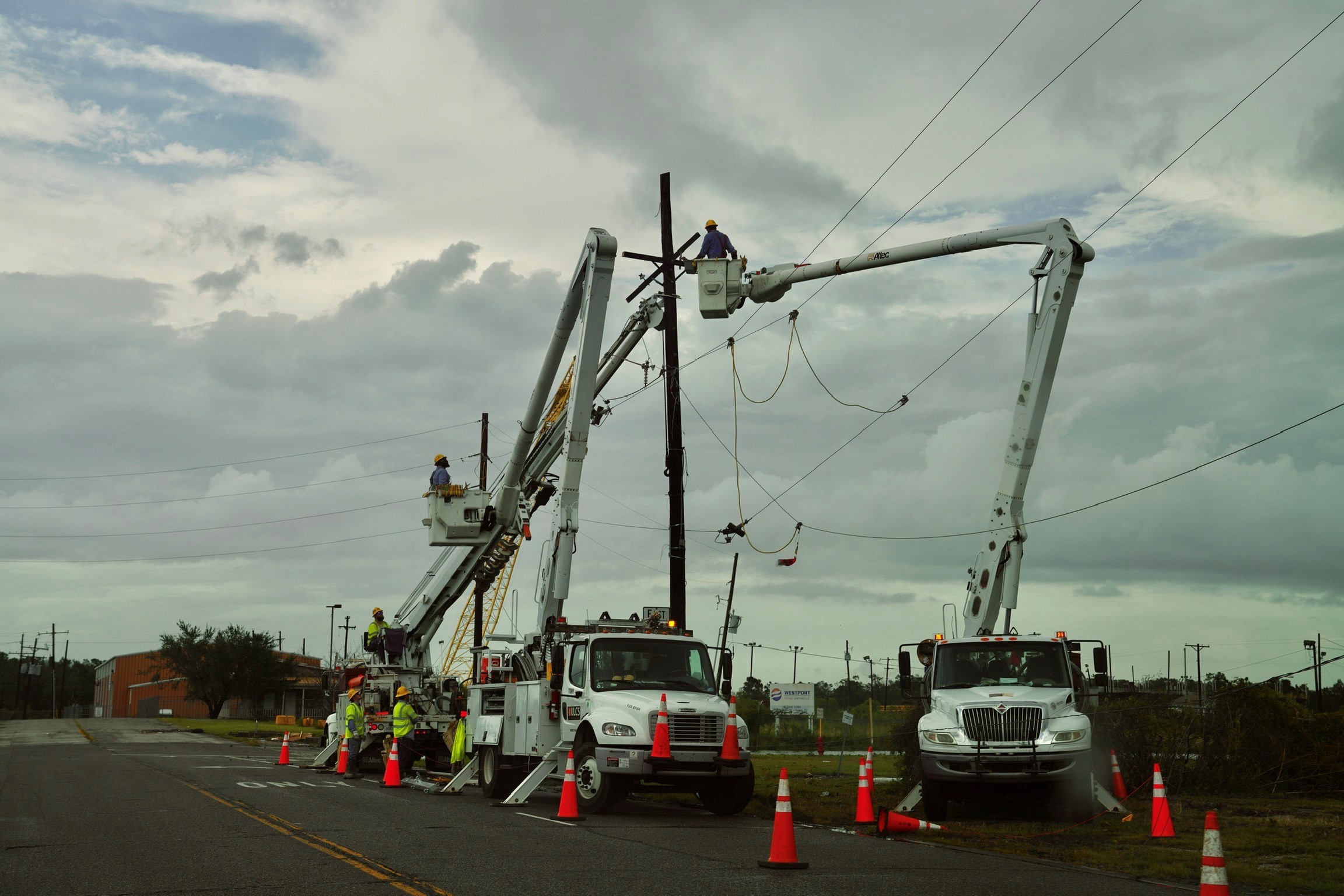 Power crews work on damaged power lines