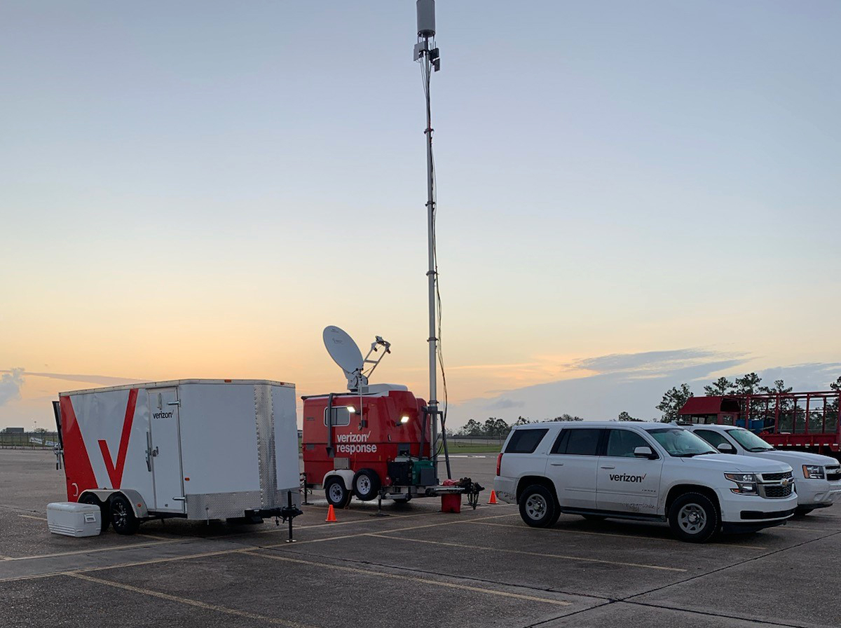 Mobile cellular tower set up on a parking lot with other vehicles parked