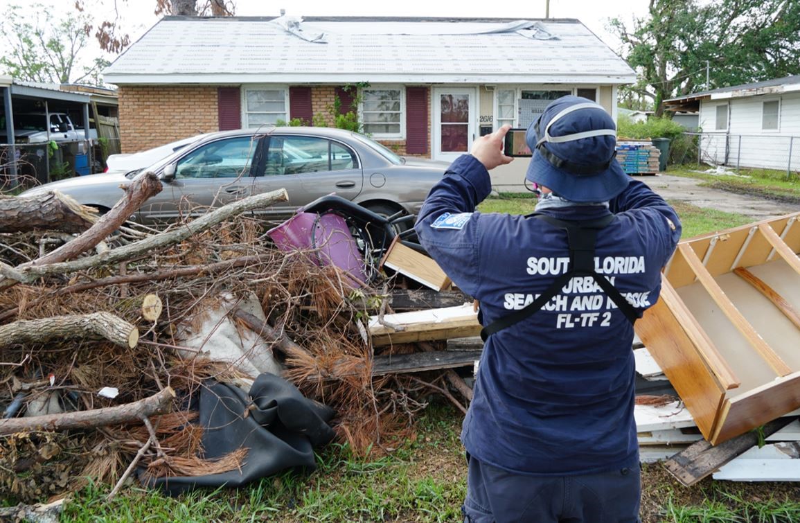 Florida Task Force 2 search and rescue member surveys damage from Hurricane Delta.