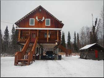 A brown wooden house elevated off the ground 