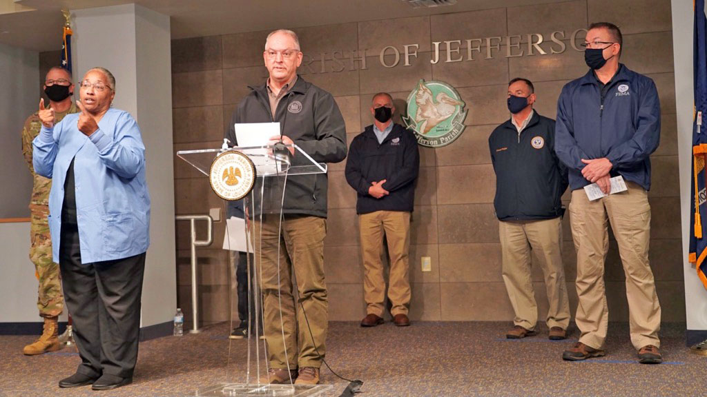 Louisiana Governor Jon Bel Edwards updates the media outside of the Jefferson Parish Department of Emergency Management operations center as FEMA Administrator Pete Gaynor (far right) and others look on.