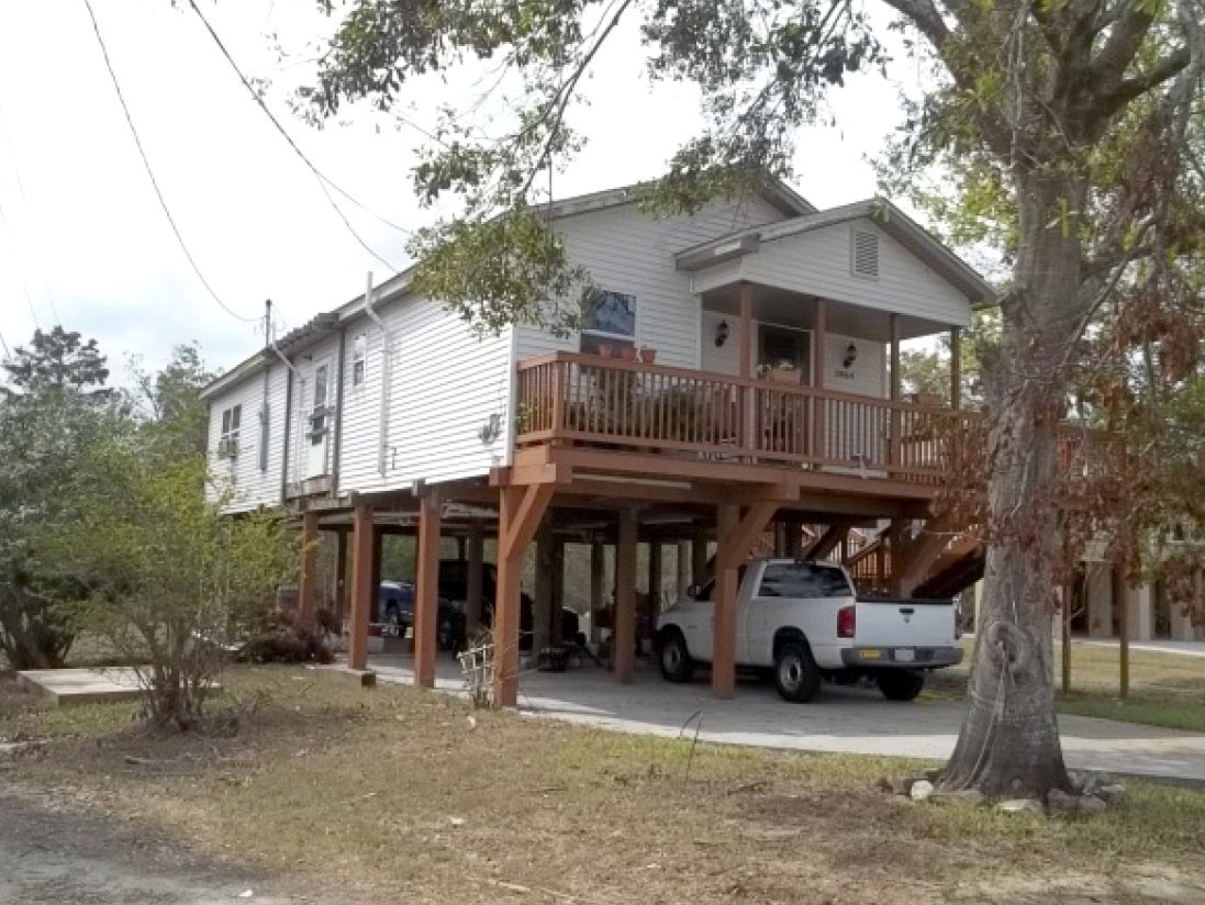 elevated home with pressure-treated driven piles