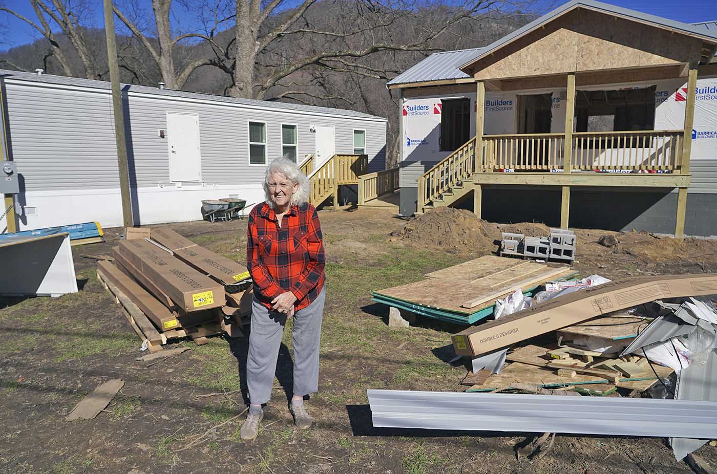 Woman in front of house under construction