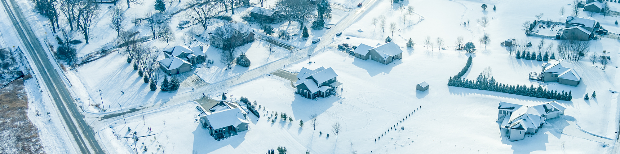 neighborhood ariel view where every home is covered with snow