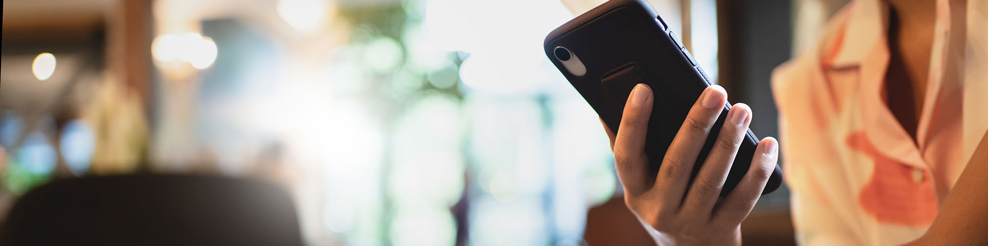 A person holding an iPhone in their hand.
