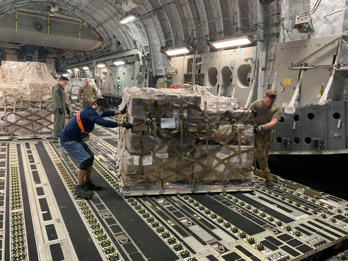 Crates of supplies inside the cargo area of an airplane
