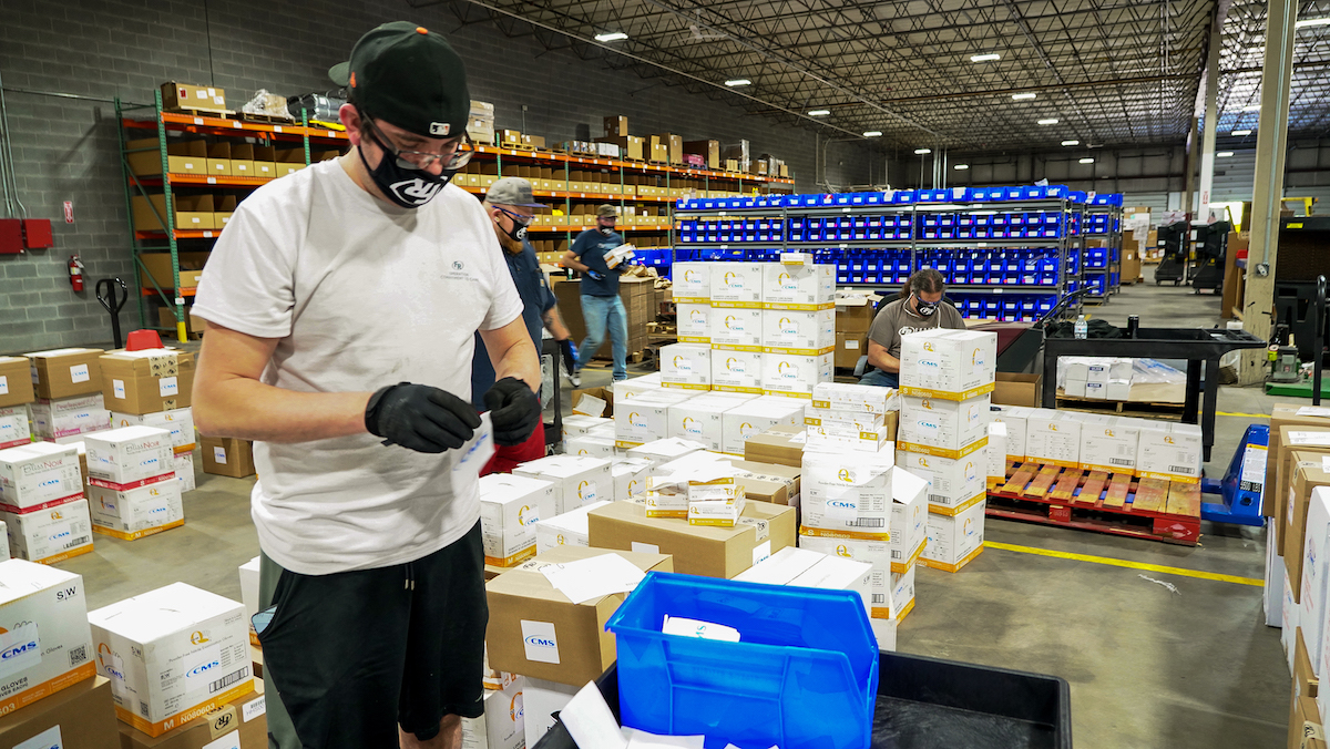 A warehouse employee sorts PPE.