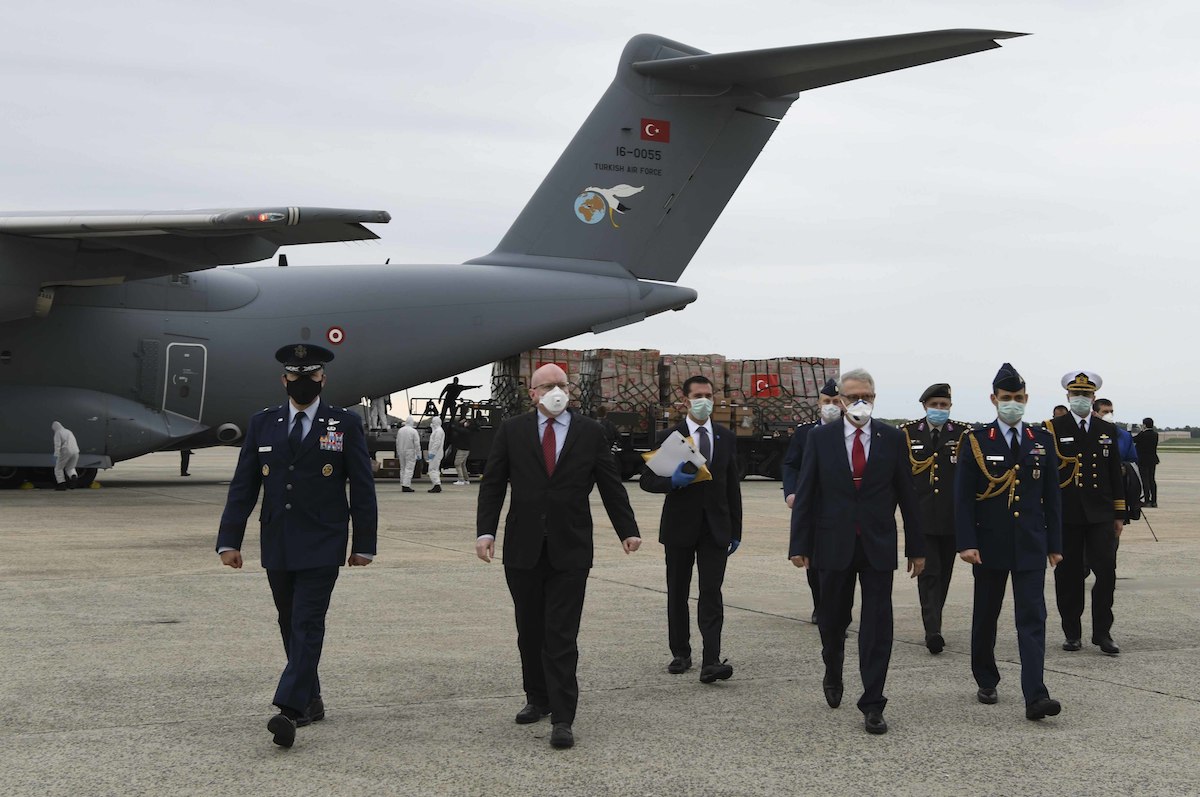 U.S. and Turkish leadership walk away from a Turkish Airbus A400M Atlas filled with medical supplies