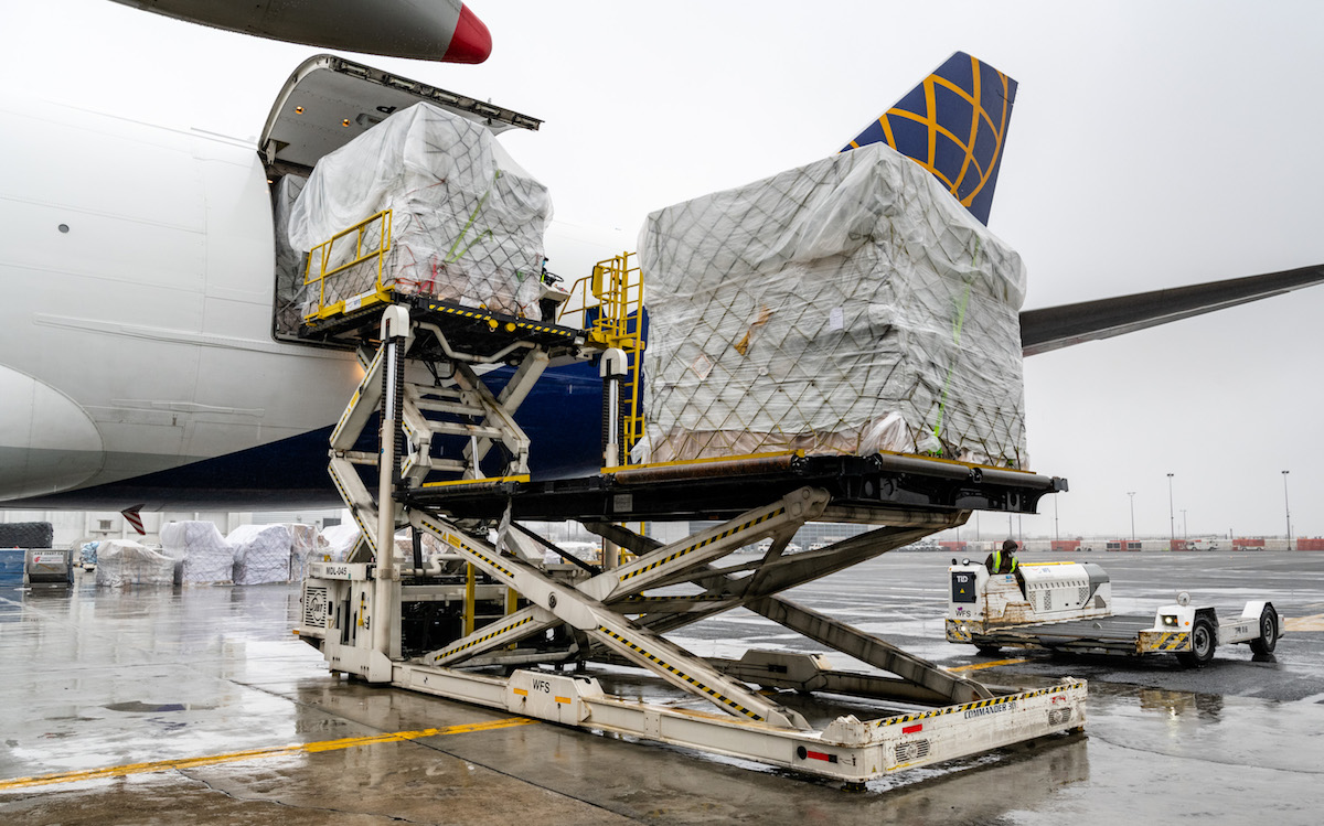Pallets of cargo offloaded from plane.