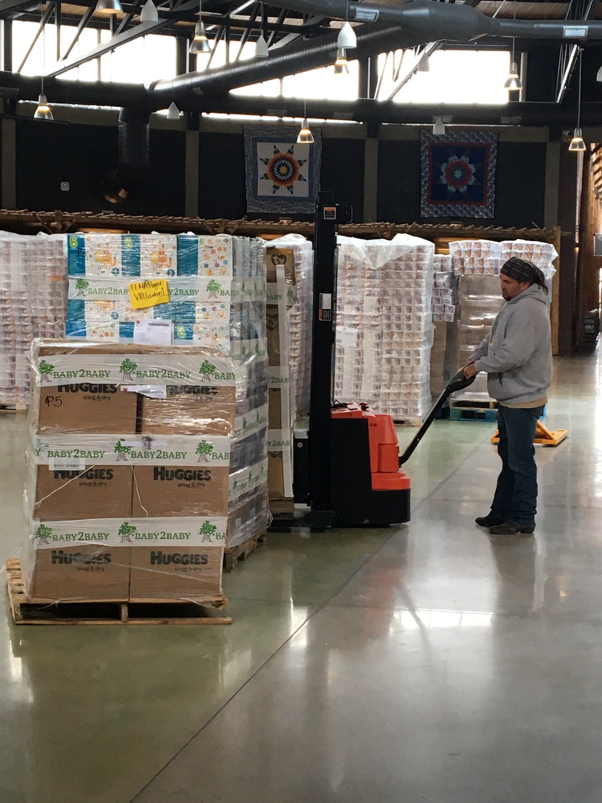 Man looks at boxes of baby supplies.