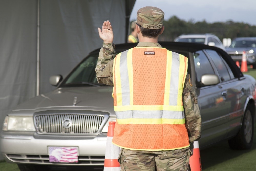 A male soldier directing traffic