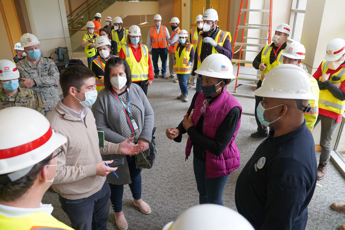 People tour a hospital, wearing face masks during COVID-19