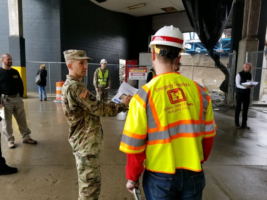 a solider talking to an U.S. Army Corps of Engineer male worker