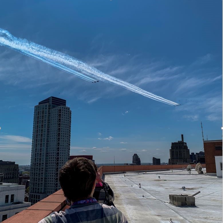 8 planes flying over a building