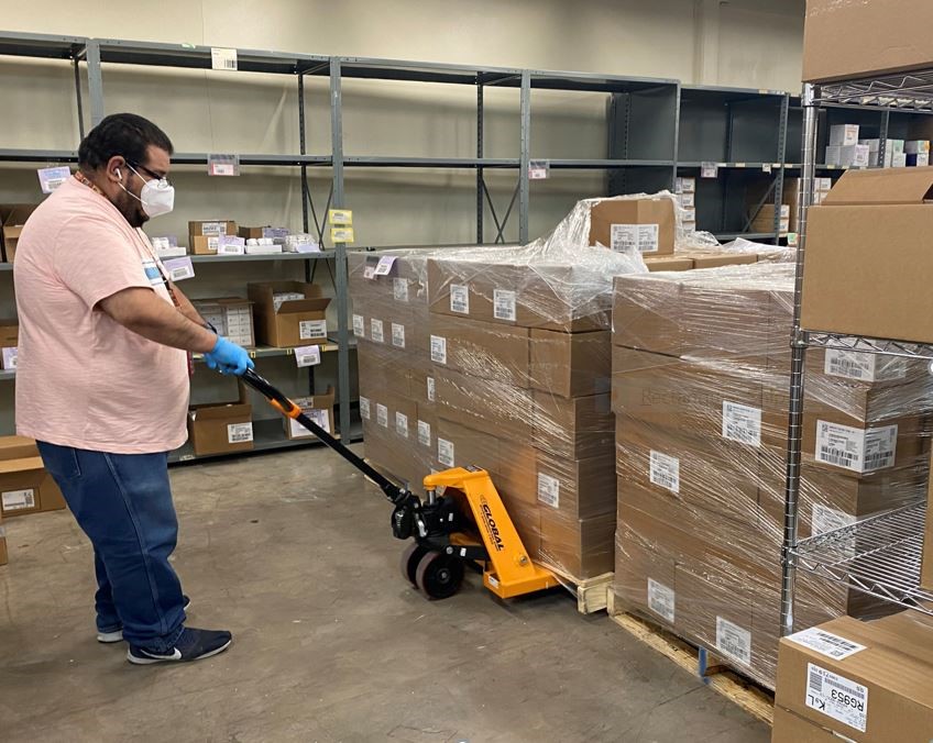 A man lifting boxes with a forklift