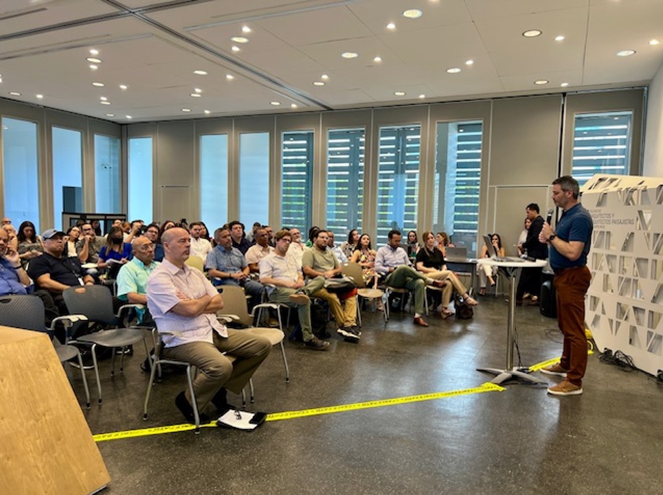 Man making Power Point presentation to a group of people.
