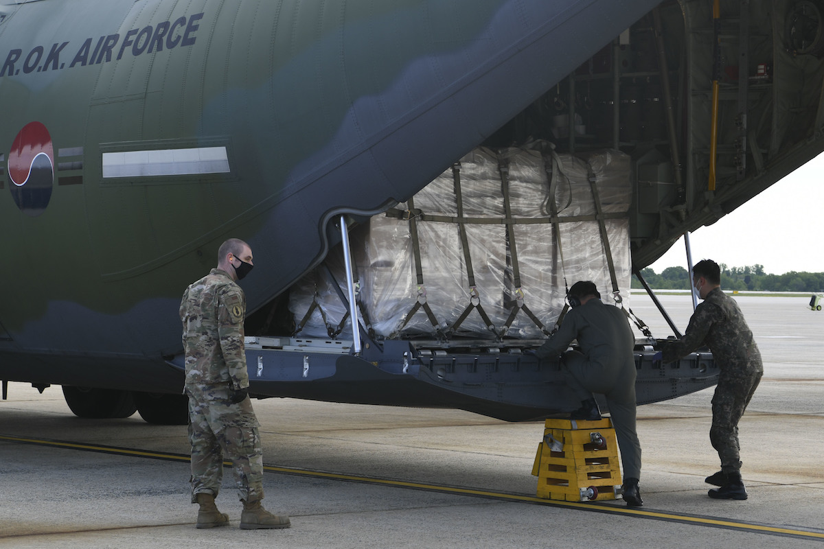 Airmen and South Korean aircrew unload a Republic of Korea C-130 aircraft.