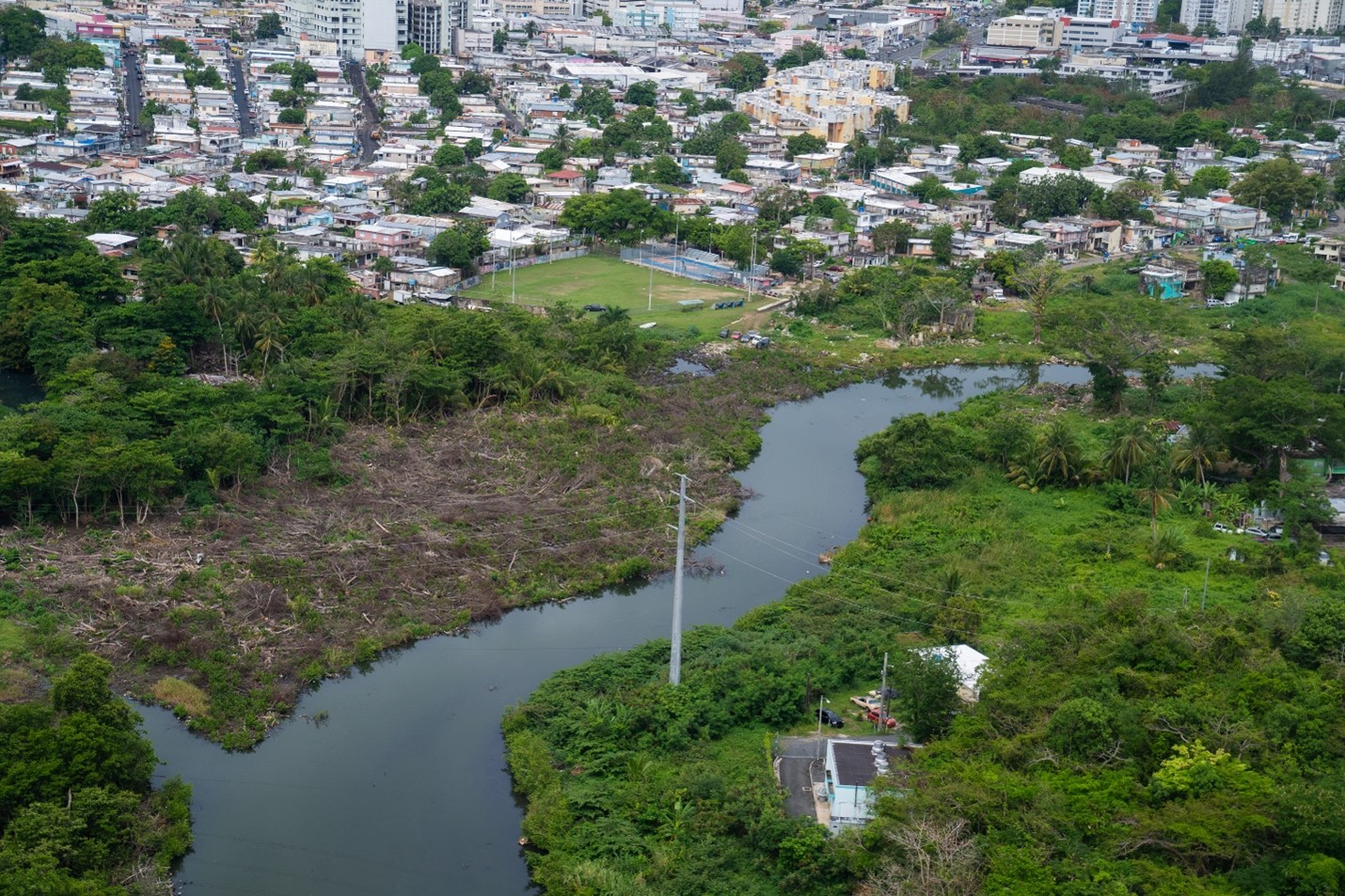 Aerial view of the Martin Peña Channel. Cluster of houses can be seen at the back.