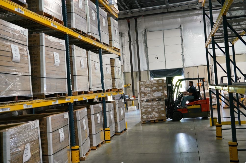 logistics specialist stages a pallet of personal protective equipment