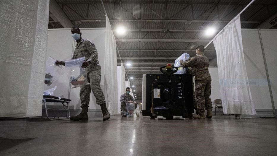 3 male soldiers moving medical supplies