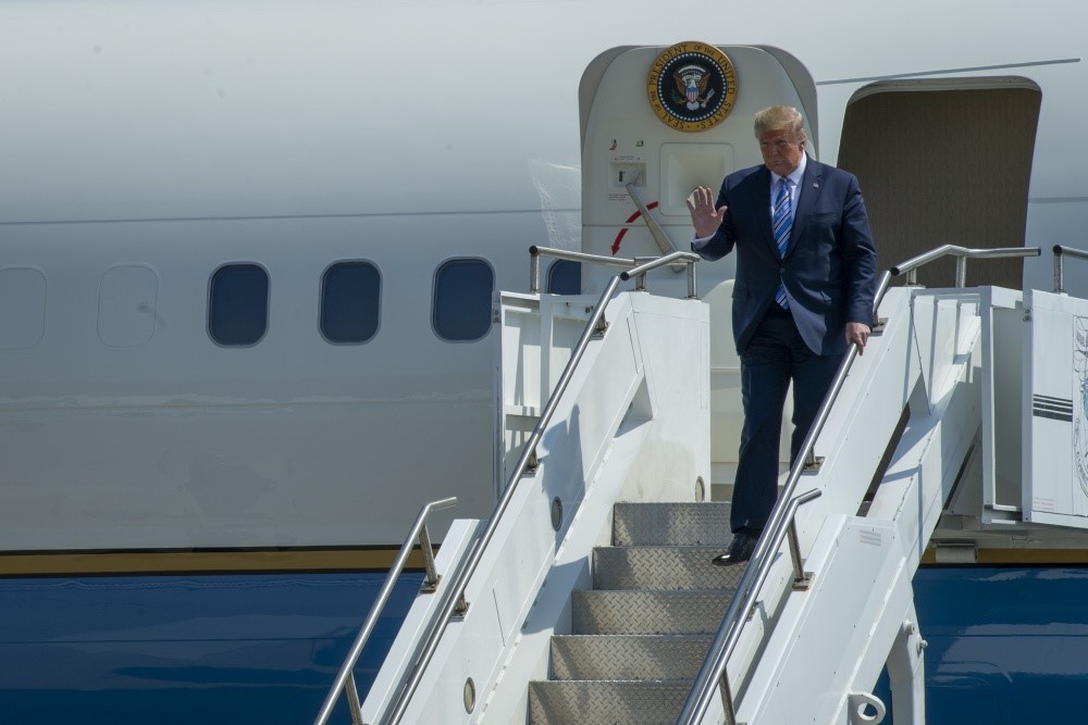 President Trump walking down the stairs from his airplane