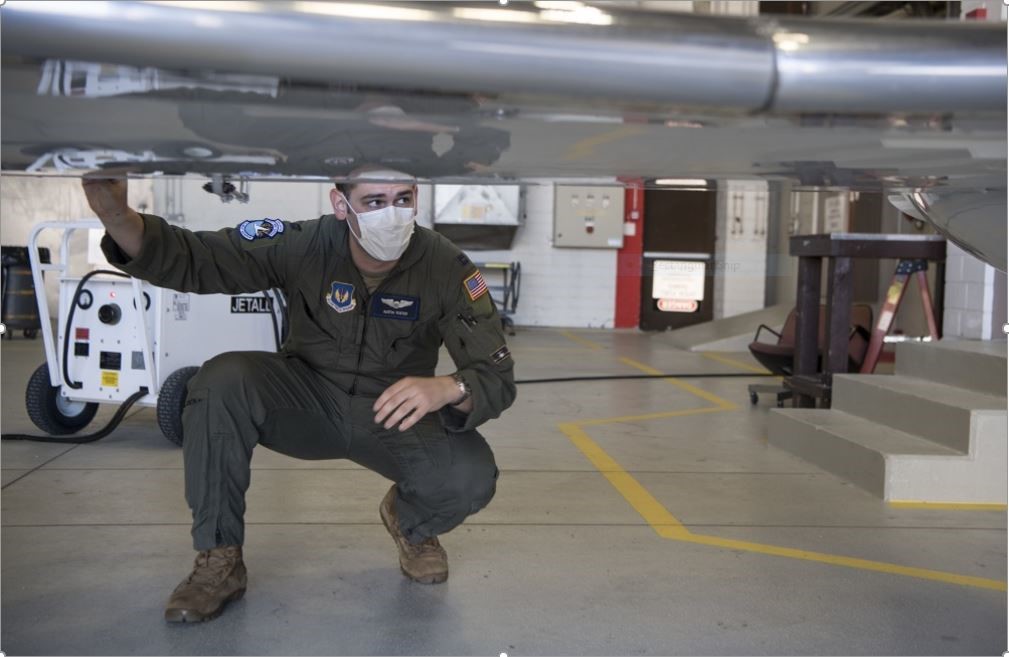 An Air Force-man is under the wing of a plan