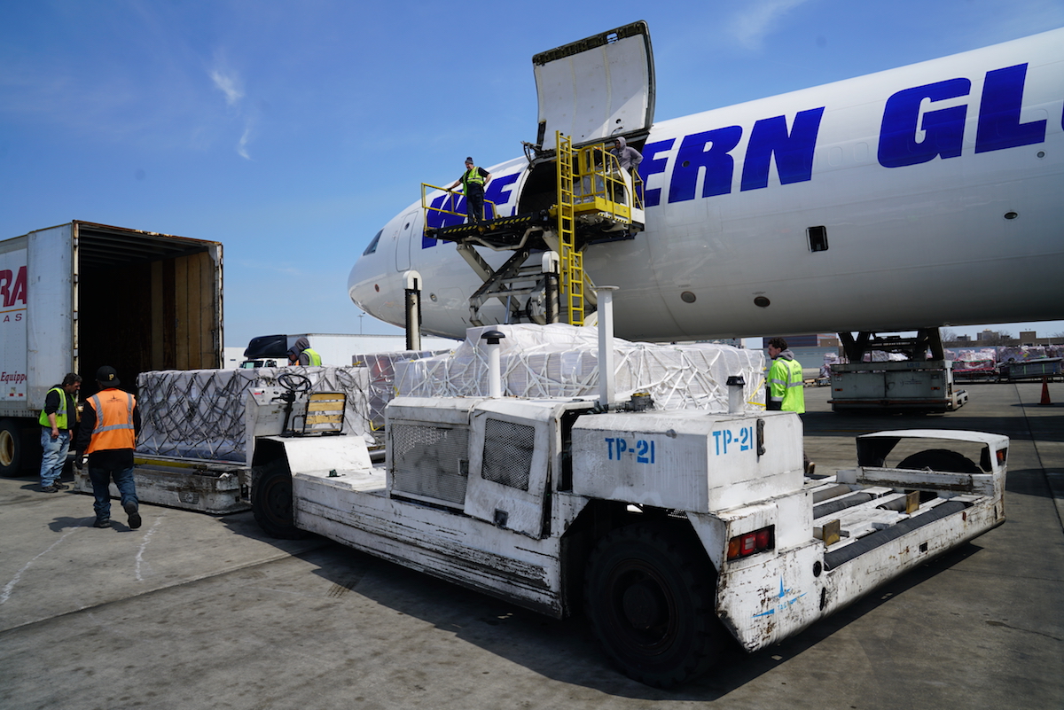 Medical supply cargo is unloaded from a plane into a truck. 