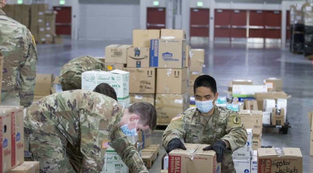 soldiers going through boxes in a warehouse