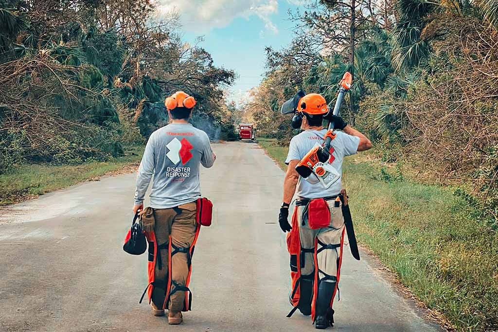 Two men walk down road.