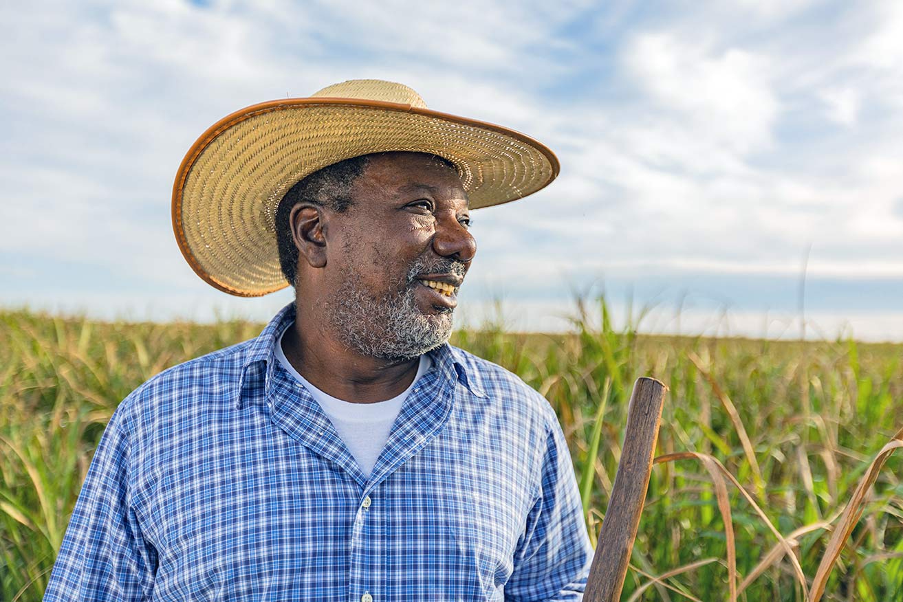A man wearing hat looks out at a field.