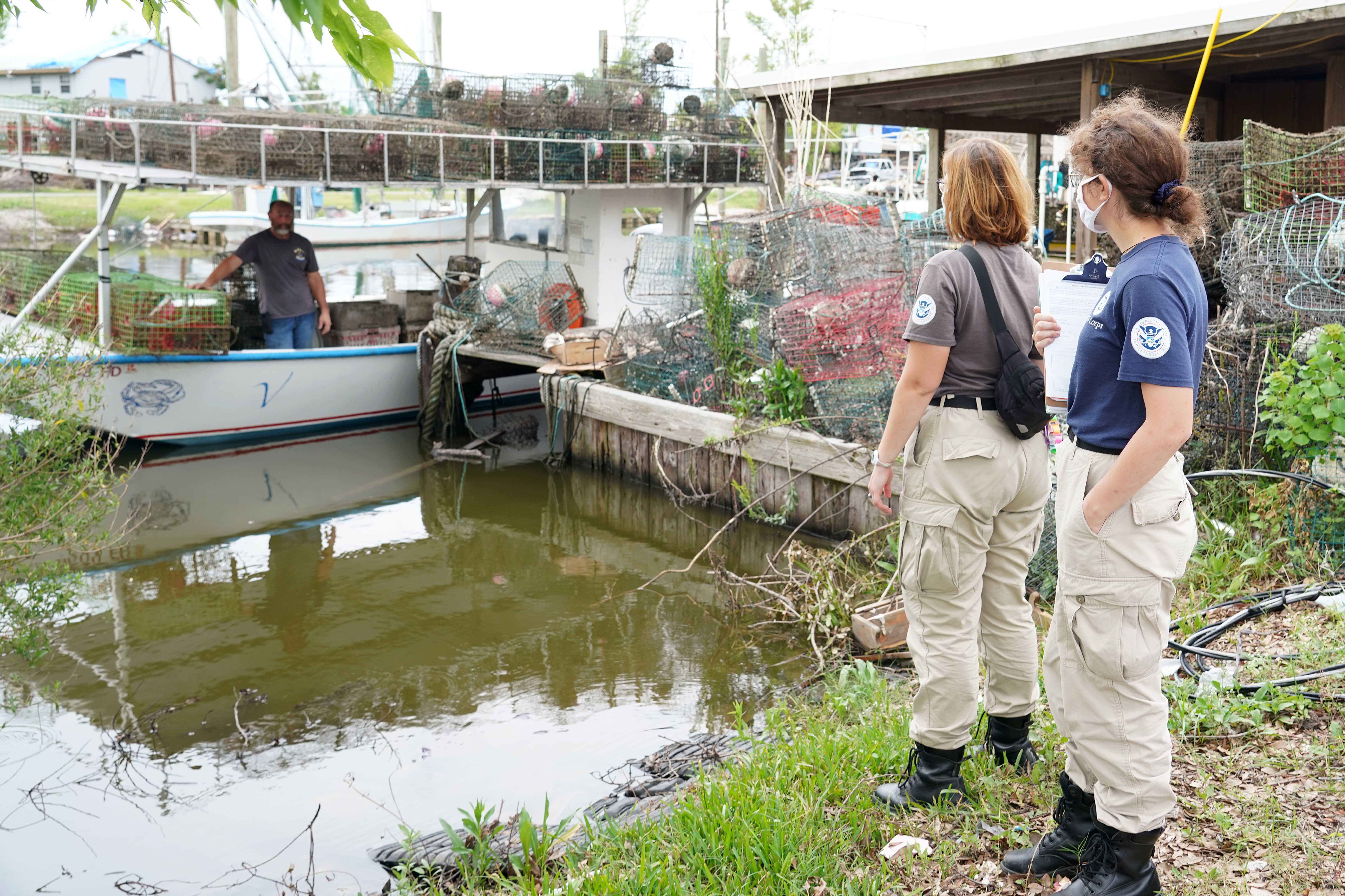 Members of a FEMA Disaster Survivor Assistance crew walk door to door (or boat to boat) to help residents apply for assistance after Hurricane Ida.  Photo by Julie Joseph, FEMA.