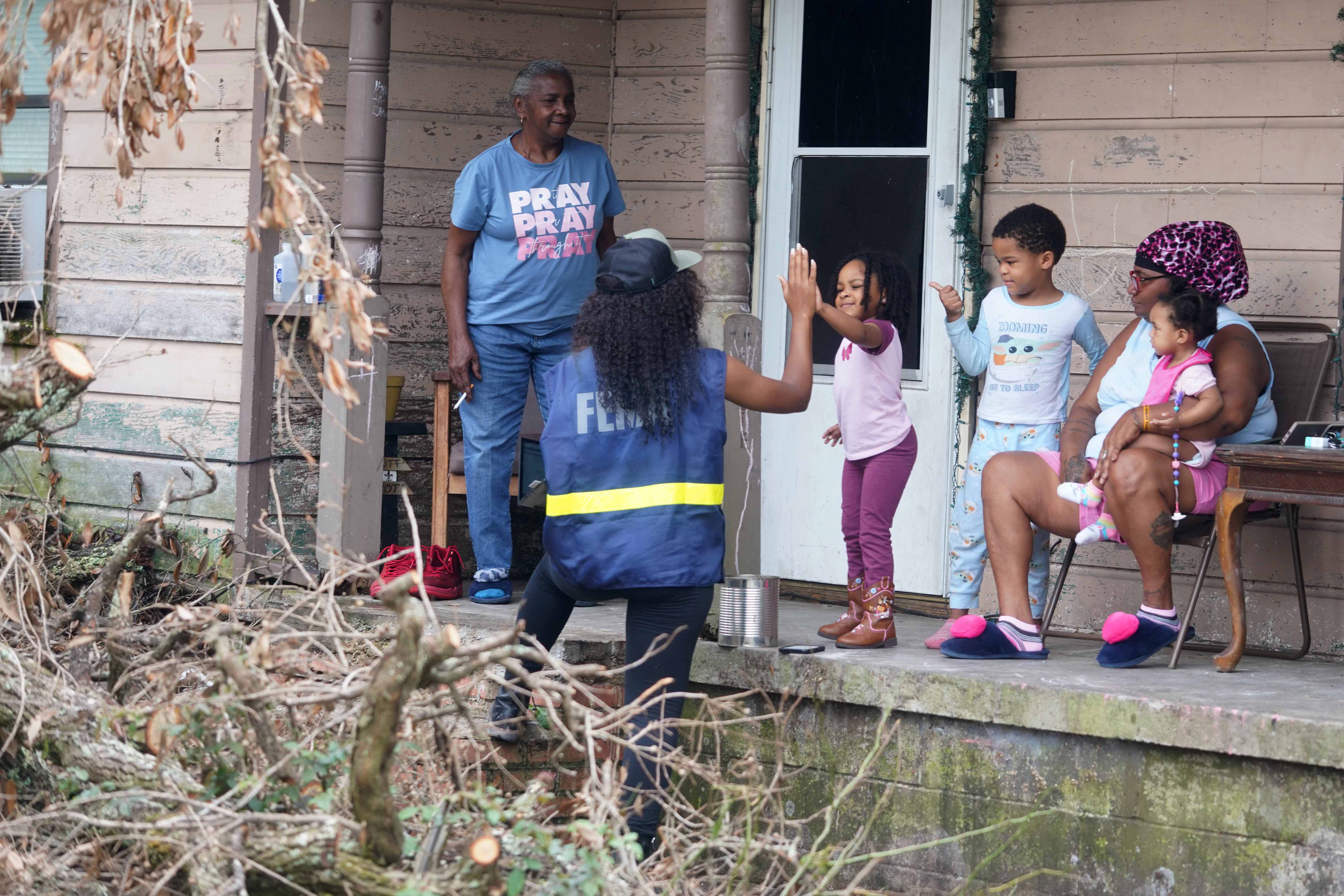 Members of a FEMA Disaster Survivor Assistance crew walk door to door to help residents of Houma apply for assistance after Hurricane Ida.  