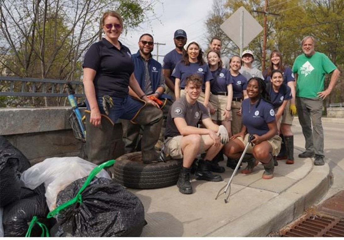 FEMA Administrator Deanne Criswell (far left), AmeriCorps Chief Executive Officer Michael Smith, Parks & People Executive Director and President Steve Coleman (far right) and FEMA Corps team members after the Earth Day service project at Marvin Gaye Park April 22. The team removed trash from the park and planted trees during the event.