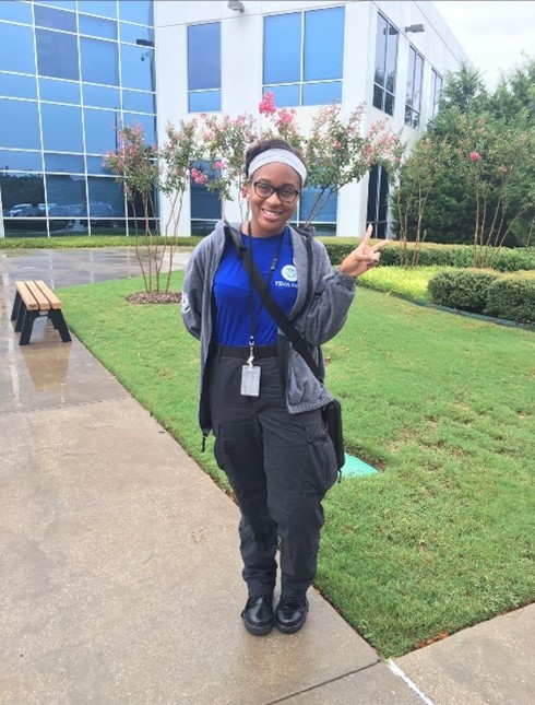 Bookman standing outside the FEMA Individual Assistance National Processing Center in Denton, Texas. Bookman and her FEMA Corps team would serve disaster survivors calling the FEMA helpline.  