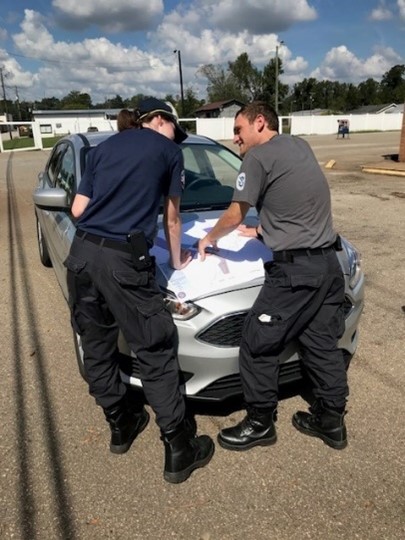 Herron and a corps member plan their next damage assessment after flooding from Hurricane Florence during Herron’s FEMA Corps experience. 