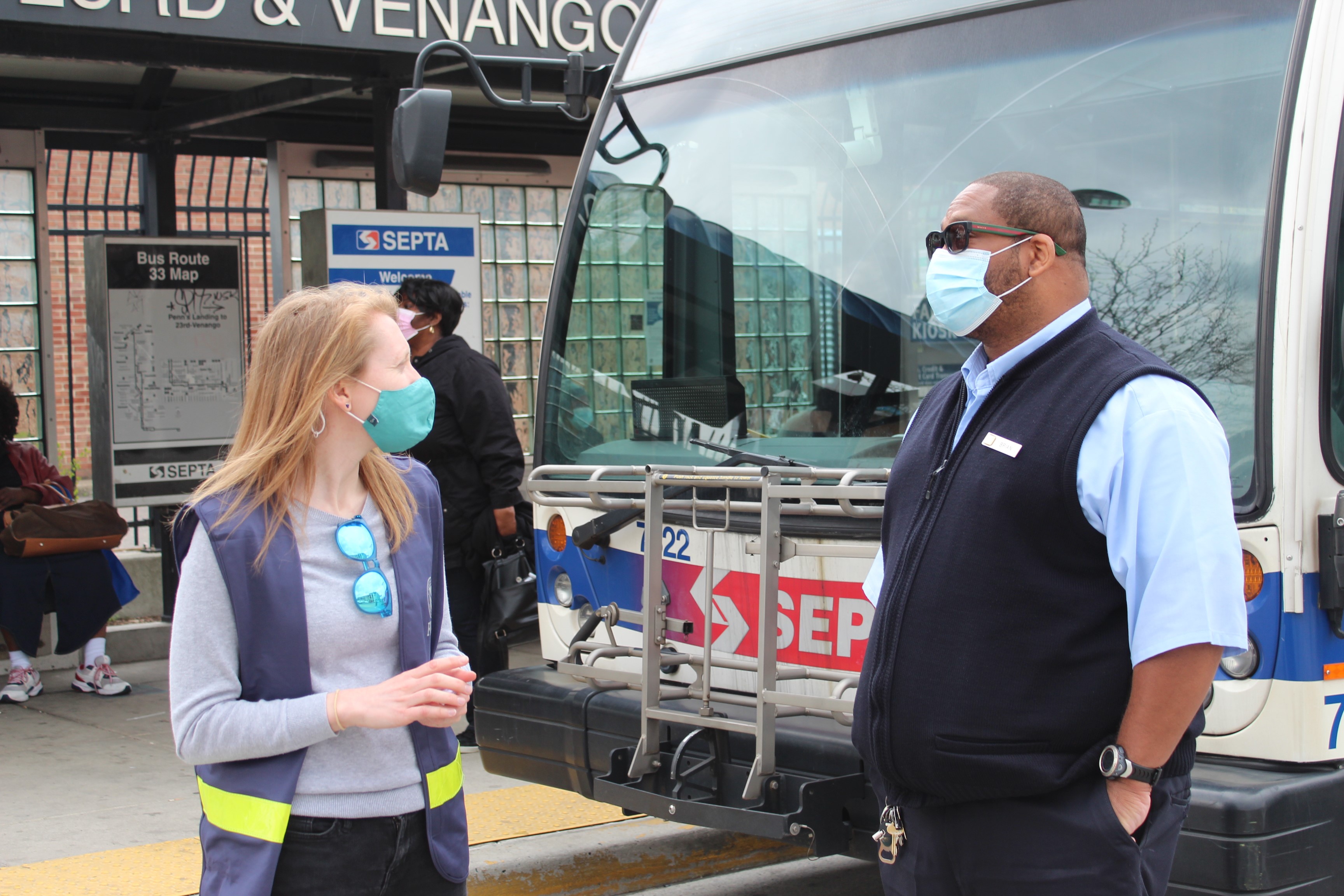Maggie Dunn speaks with a SEPTA employee while canvassing in Philadelphia, Pennsylvania. SEPTA and FEMA partnered to provide free transit passes to residents for whom transportation may be a barrier to accessing the community vaccination clinics.