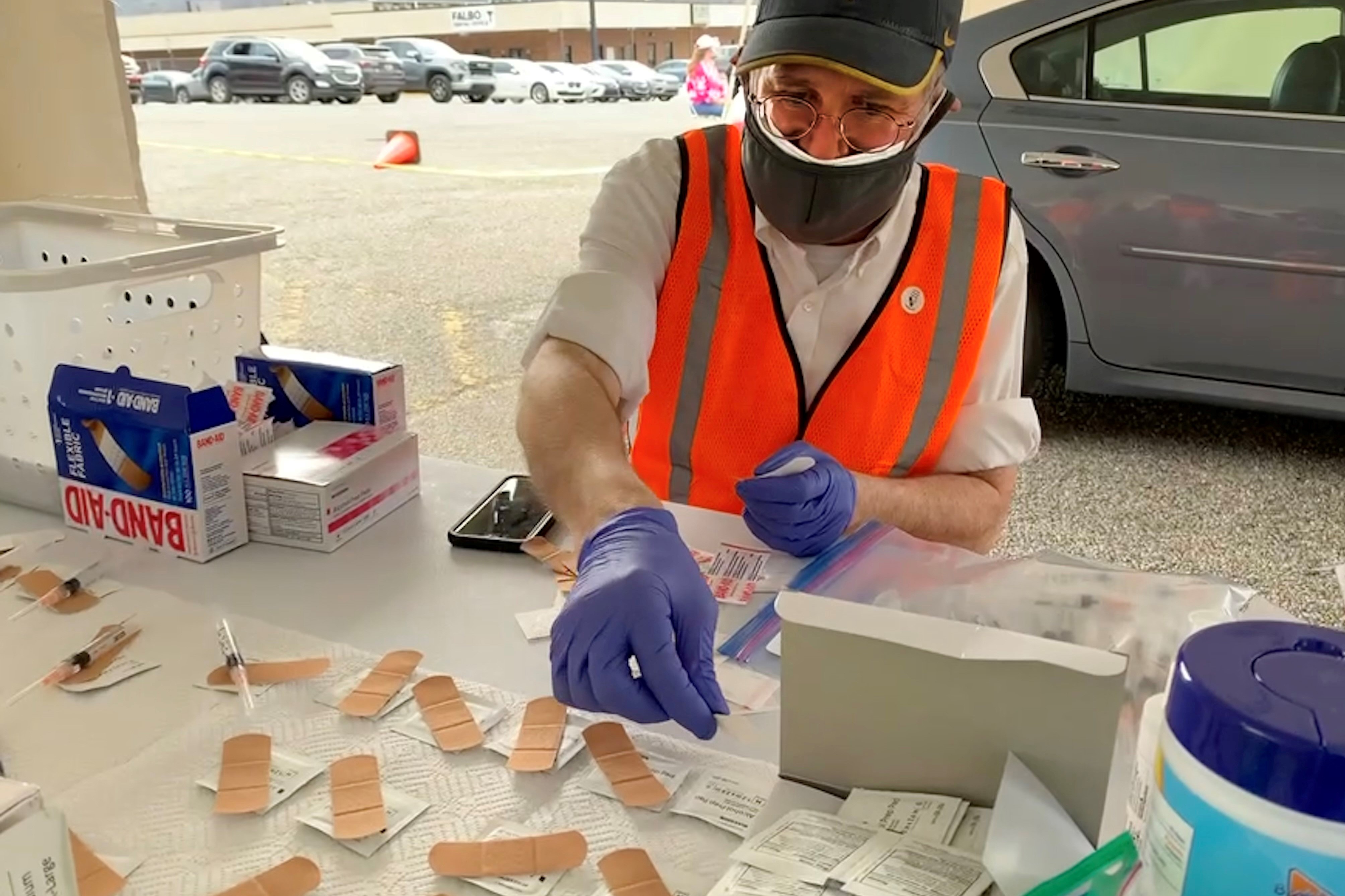 A man assembles vaccination kits at the mobile vaccination clinic sponsored by West Virginia Voluntary Organizations Active in Disasters
