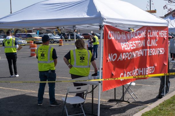  A walk-up mobile vaccination center is set up in a grocery store parking lot. 