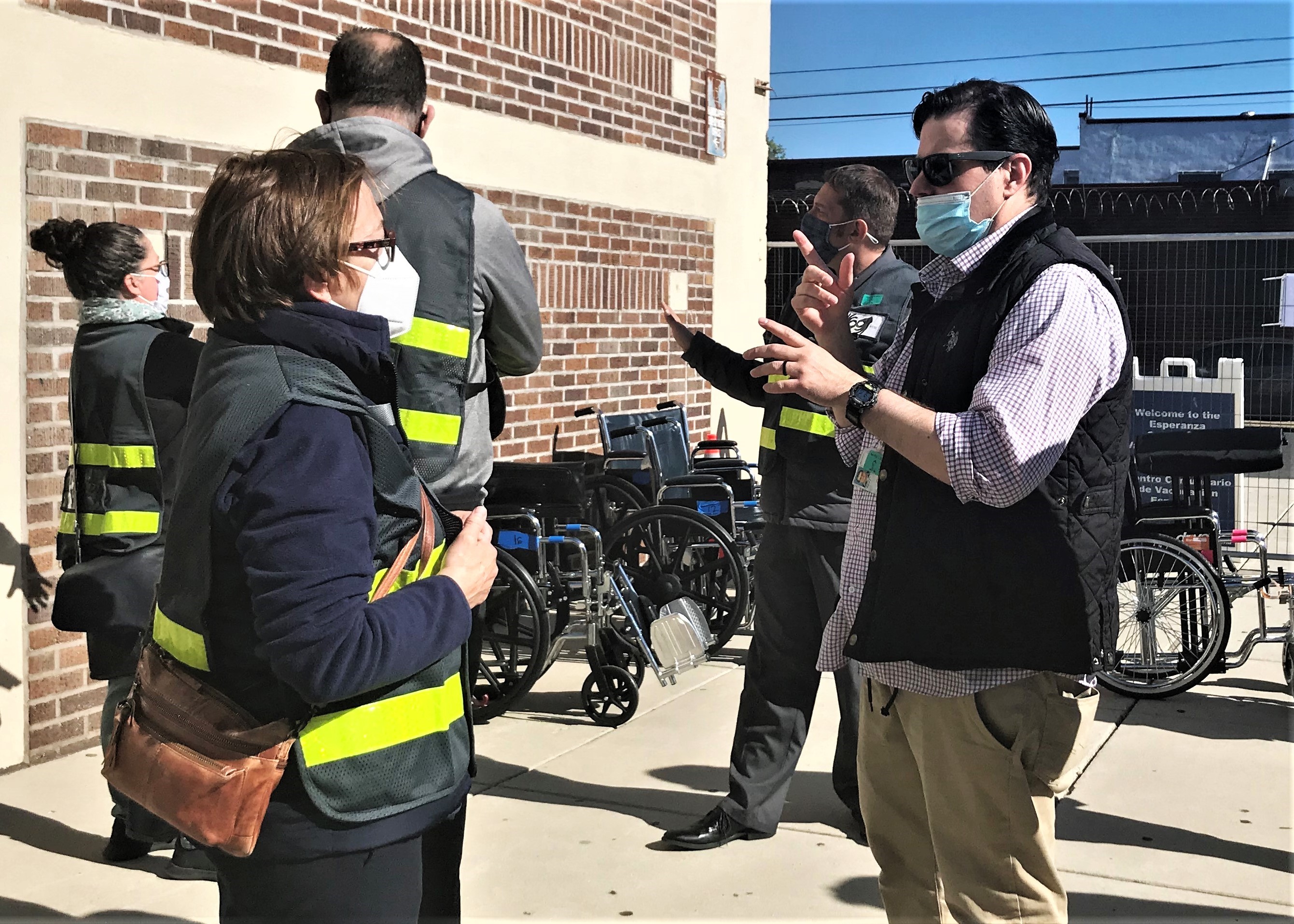 PJ Mattiacci communicates with a staff member at the Esperanza Community Vaccination Center in North Philadelphia.