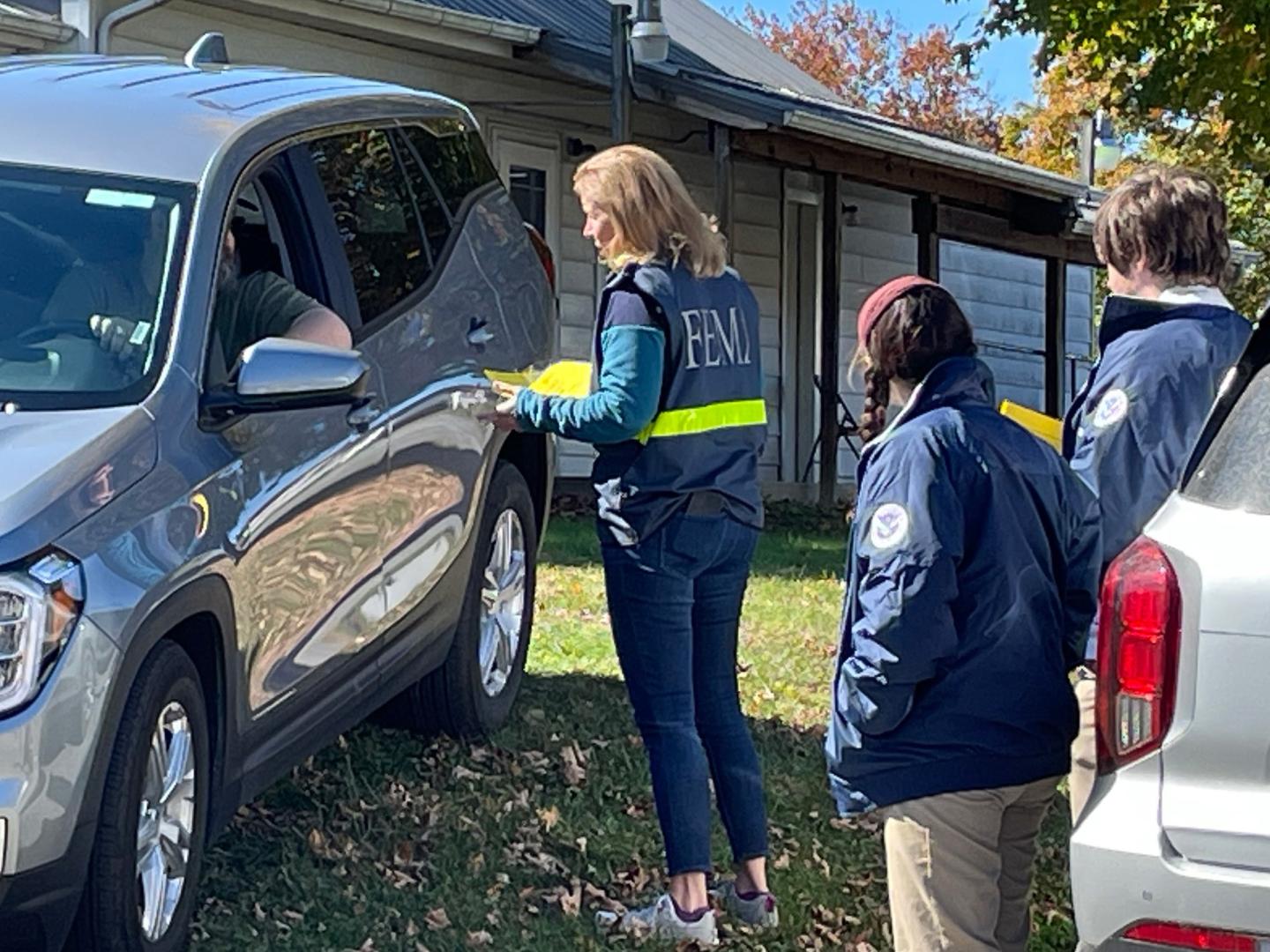 dsat standing next to a suv