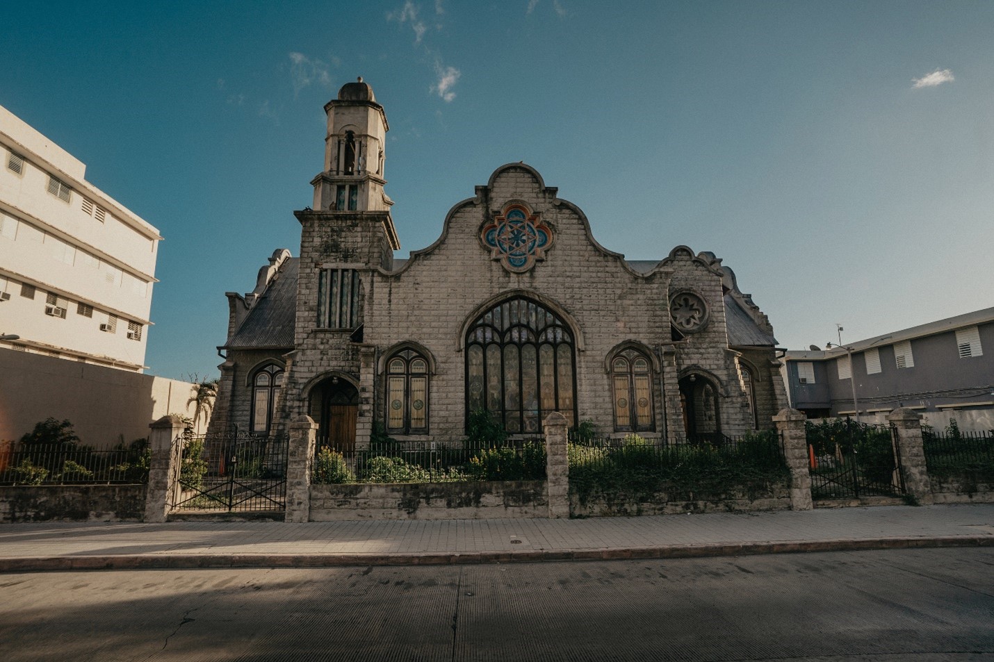 Front view of church with brick walls and stainless glass windows.