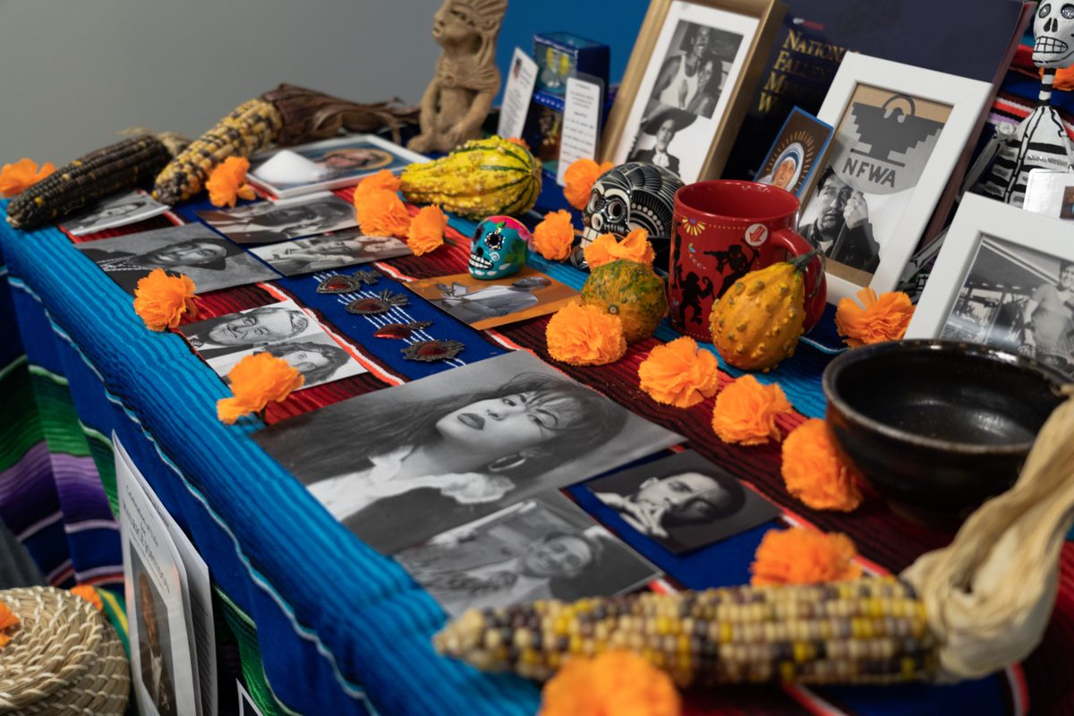 Photos, pumpkins and other items displayed on desk.