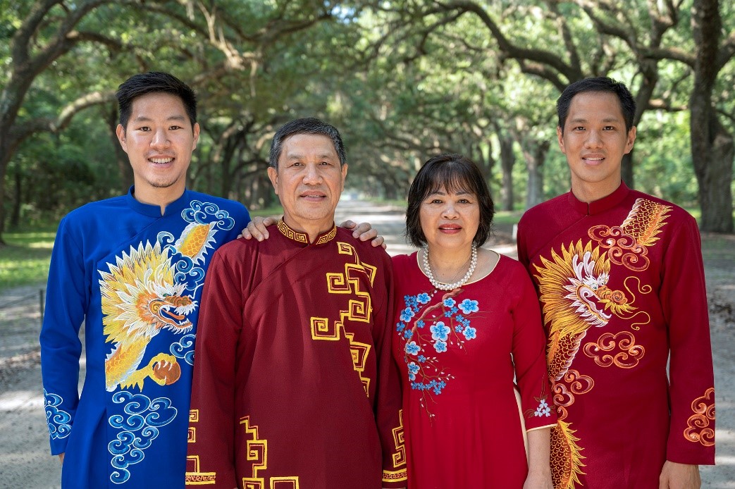 In a family portrait, Minh Phan, his parents, and brother wear Áo dài, the beautiful national garment of Vietnam