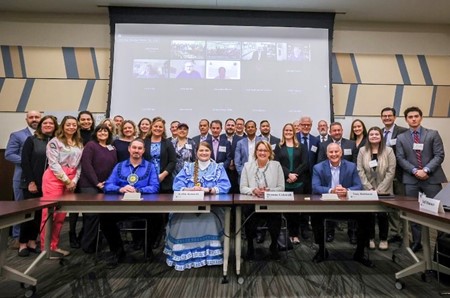 FEMA Administrator Deanne Criswell, (center right), Region 6 Administrator Tony Robinson (far right); FEMA National Tribal Affairs Advisor Kelbie Kennedy (center left); and National Advisory Council Chairman Jeff Hansen, Choctaw Nation of Oklahoma takes a photo with the NAC members who attended the meeting in person and virtually. 