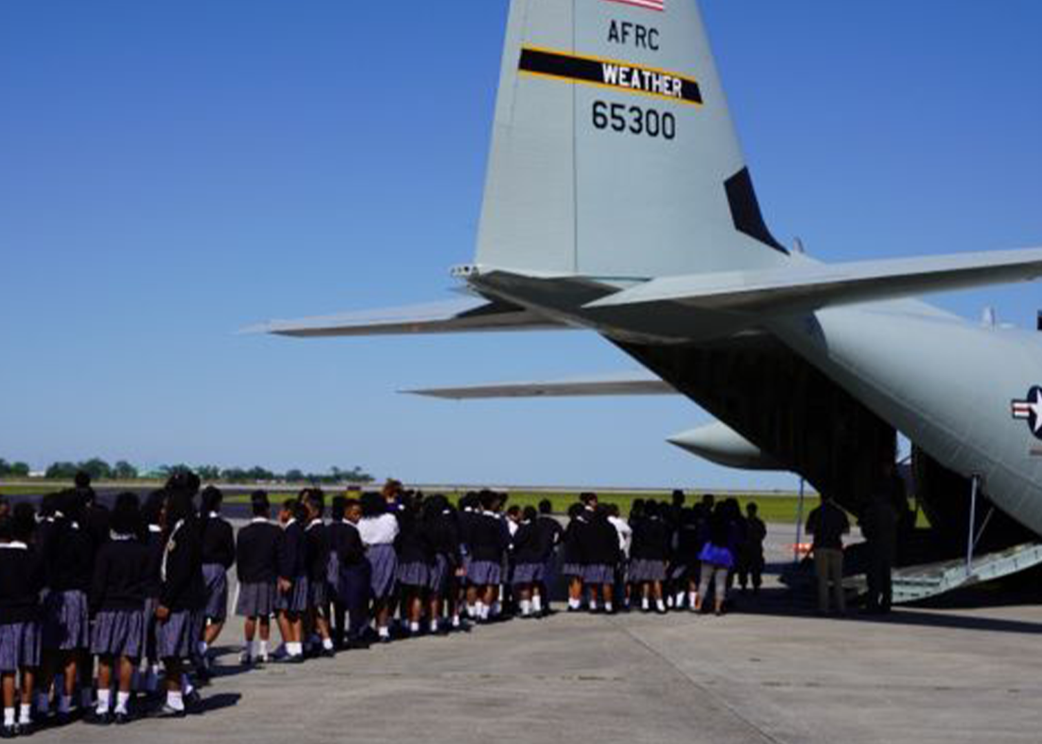  Fourth and fifth grade students from St. Mary's Academy in New Orleans line up to tour the Airforce Reserves Command Weather Airplane at Lakefront. 