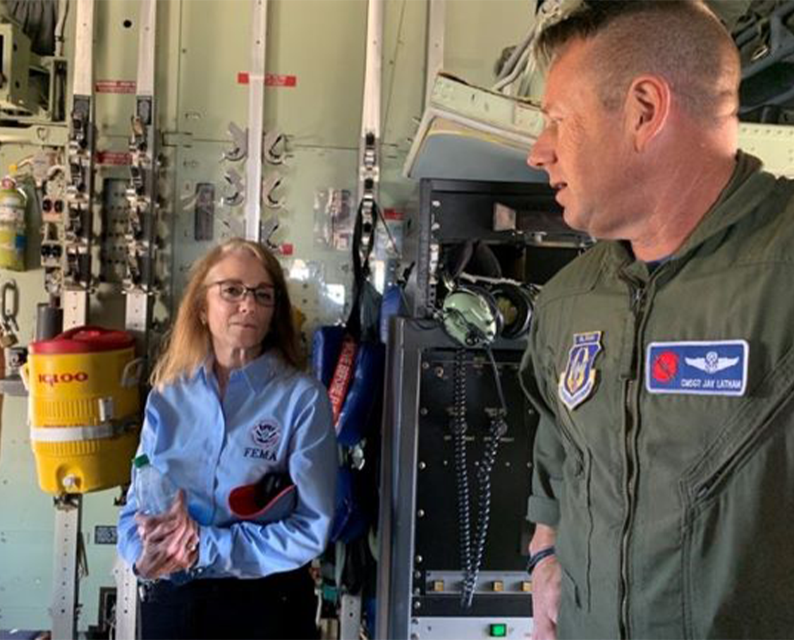 FEMA Region 4 Regional Administrator Gracia Szczech chats with crew member Chief Master Sgt. Jay Latham of the Hurricane Hunters team aboard one of the team’s planes at Jackson’s Medgar Wiley Evers International Airport.