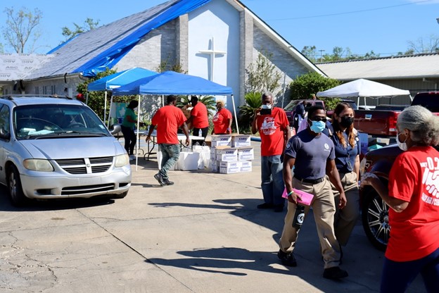 DHS Director of Faith Based and Neighborhood Partnerships Marcus Coleman and his team meet with the pastor and local volunteer organizations at the Tchoupitoulas Chapel in Reserve, Louisiana, to assist to assemble food and supply kits and boxed lunches for those affected by Hurricane Ida. 
